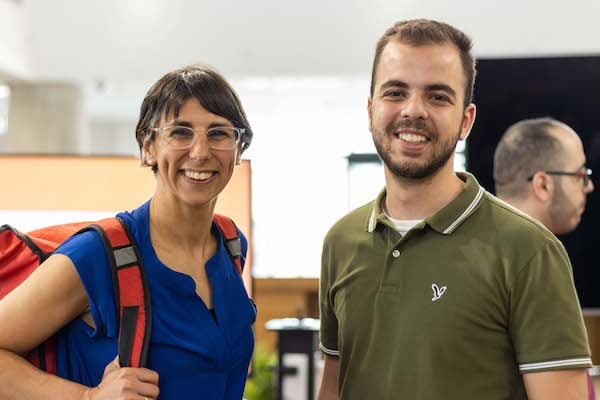 Two smiling people in an office